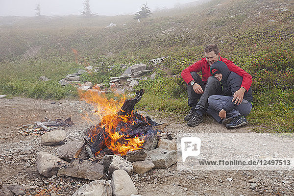 Father With His Son Near A Camp Fire