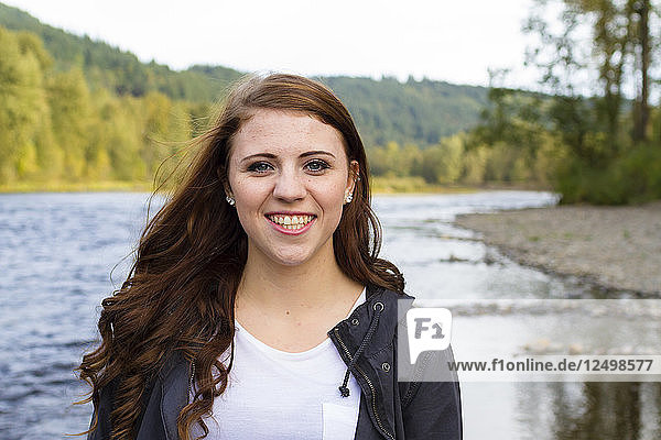 Female high school senior poses for a portrait outdoors at Armitage Park in Eugene Oregon. Senior portraits are a popular photo session that celebrates a young adult's entry into adulthood.