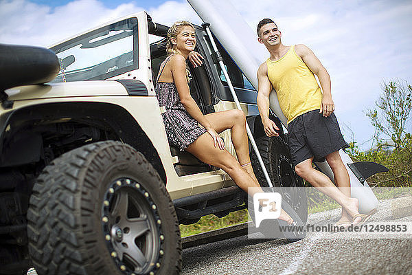 Two Smiling Friends Enjoy Spending Time Near Jeep In Florida