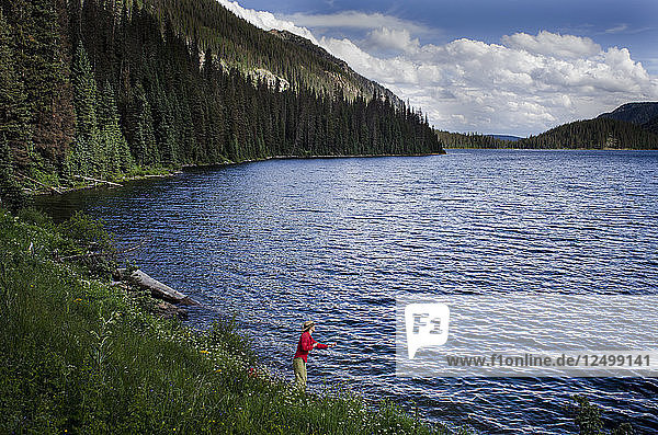 A young woman in her early thirties Fly Fishing on Emerald Lake  Weminuche Wilderness  Southwest Colorado.