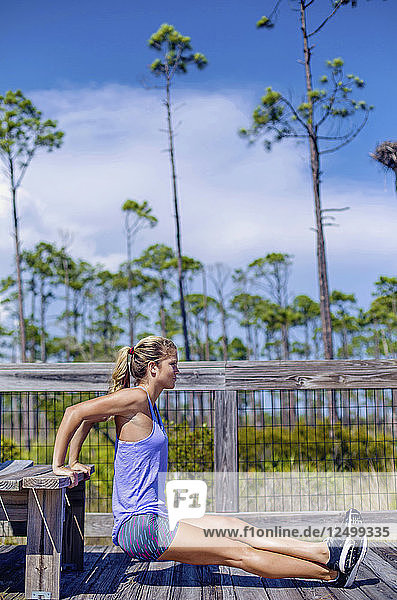 A young woman exercises and runs on the boardwalk at Big Lagoon State Park.