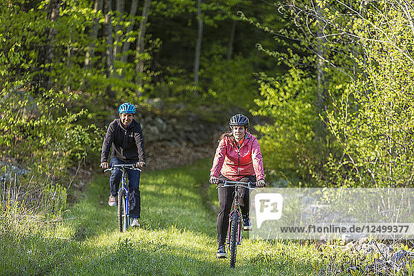 A Couple Mountain Biking On A Forest Trail Near Stonehouse Pond In Barrington  New Hampshire