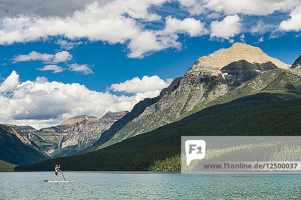 Frau Paddleboarding In Bowman Lake In Montana  Usa