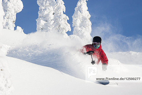 Male Skier Makes A Deep Powder Turn At Whitefish Mountain Resort In Whitefish  Montana