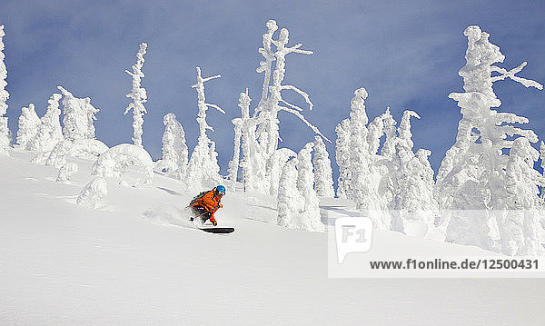 Male Skier Skiing On Snowy Landscape In Whitefish Montana Usa