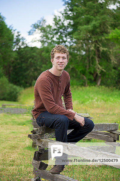 Senior portrait of a young adult in high school outdoors at a nature park in Oregon.