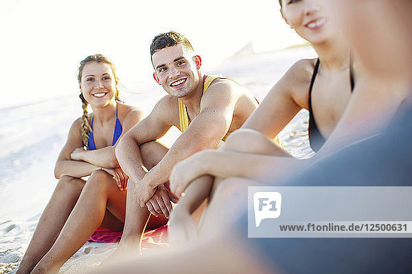 Group Of Smiling Friend Having Fun Spending Time On Beach