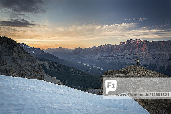 Photographer on Survey Peak at sunset overlooking mountains