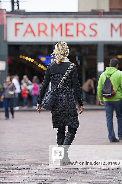 Katie Cox walking toward Seattle's downtown Pike Place Market.