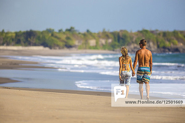 Couple are walking on the beach in Bali. Indonesia