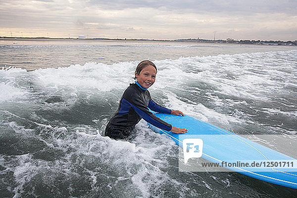 A Boy Surfs At Nahant Beach In Nahant  Massachusetts