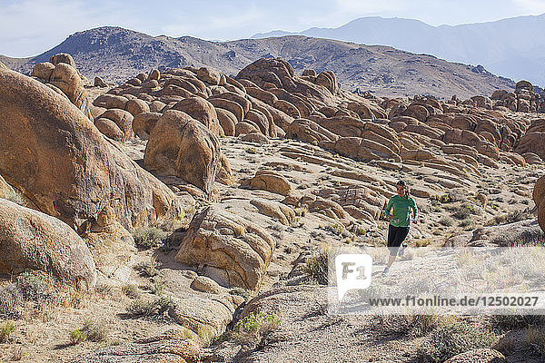 Woman Trail Running On The Desert Landscape Of Alabama Hills National Recreation Area  California  Usa