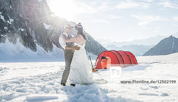 Bride Katy Pfannenstein and groom Chad Cochran dance after getting married in the mountains of Denali National Park.