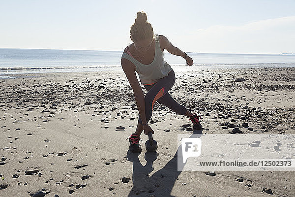 Woman Doing Exercise On Beach