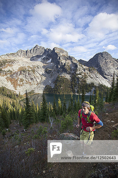 A Man Trail Running At Drinnon Pass Area Of Valhalla Provincial Park  British Columbia  Canada