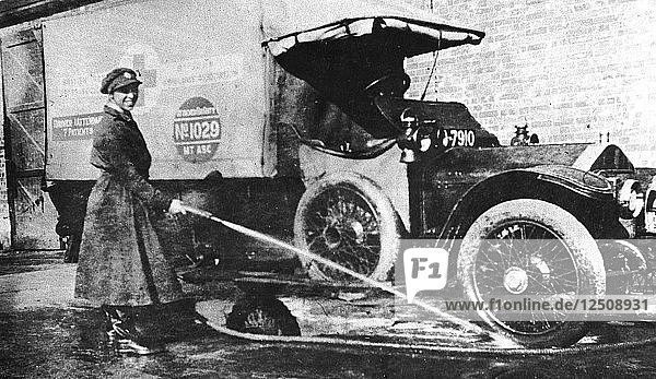 Volunteer English woman driver washing down her ambulance Cambridge World War I 1915. Artist: Unknown