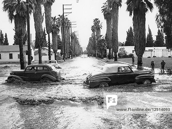 Cars on a flooded road in California  USA. Artist: Unknown