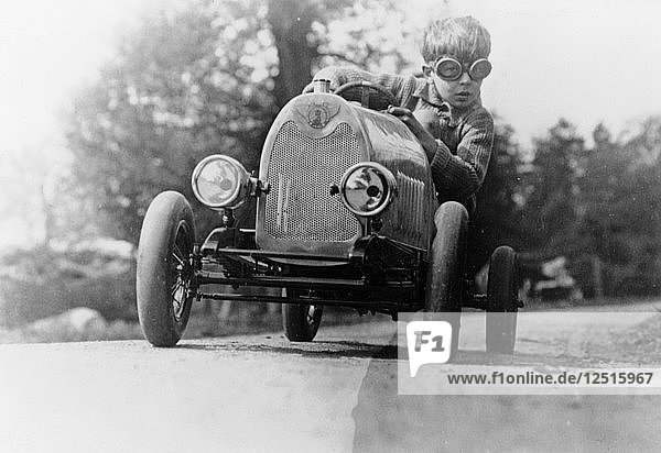 Boy in a pedal car. Artist: Unknown