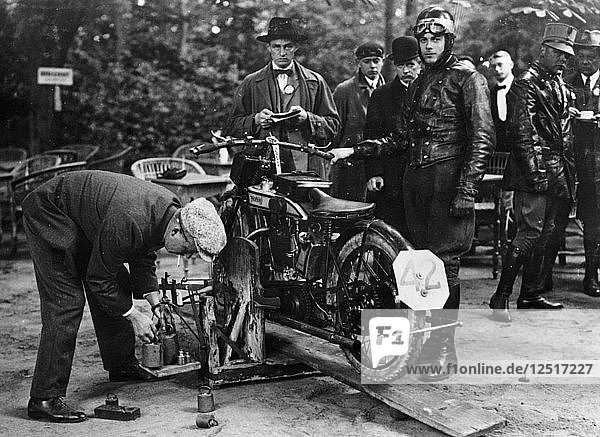 Karl Burlage having his Norton bike weighed for a TT competition. Artist: Unknown