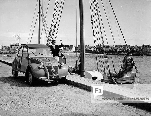 A Citroën 2CV on the quay at a harbour  c1957. Artist: Unknown