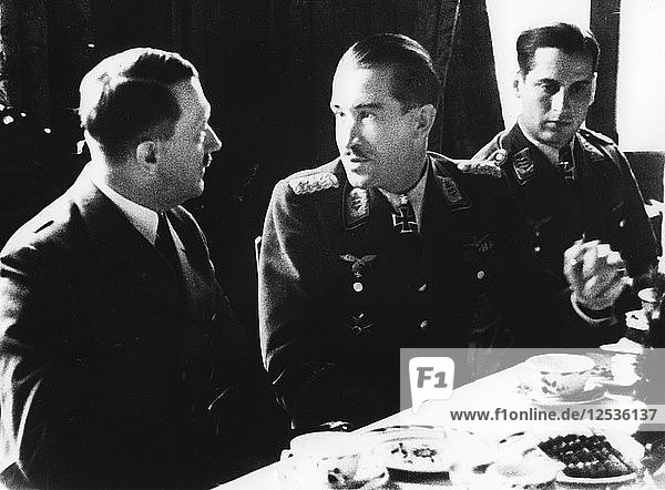 Adolf Hitler in conversation with German air force fighter ace Adolf Galland  1941. Artist: Unknown