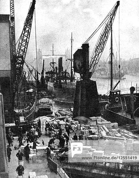 Cargo being unloaded at the docks  Upper Pool  London  1936.Artist: Fox