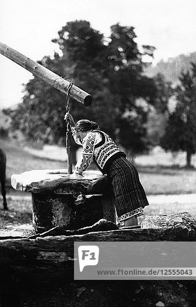 Woman getting water from a well  Bistrita Valley  Moldavia  north-east Romania  c1920-c1945. Artist: Adolph Chevalier