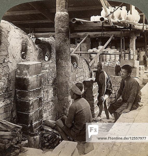 Workmen watching kilns full of Awata porcelain  Kinkosan works  Kyoto  Japan  1904. Artist: Underwood & Underwood