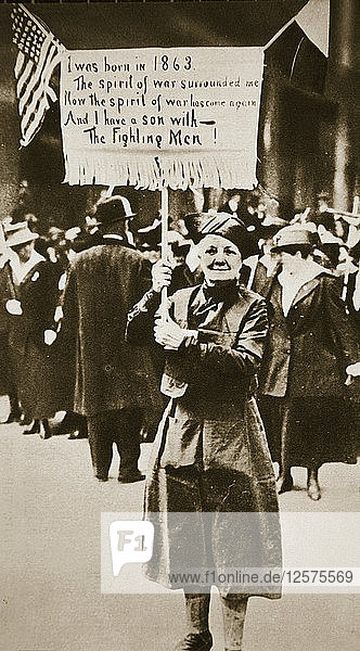 Woman holding a placard in support of the war effort USA World War I c1914-c1918. Artist: Unknown