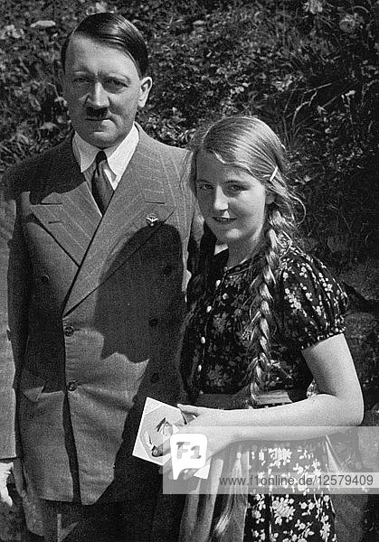 A young girl asks Adolf Hitler for his autograph  1936. Artist: Unknown