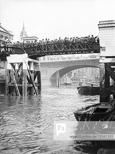 Passengers for the river bus service on the footbridge to London Bridge Pier  London  c1905. Artist: Unknown
