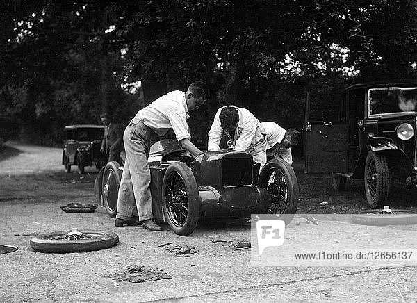 Mechanics working on Leon Cushmans Austin 7 racer for a speed record attempt  Brooklands  1931. Artist: Bill Brunell.