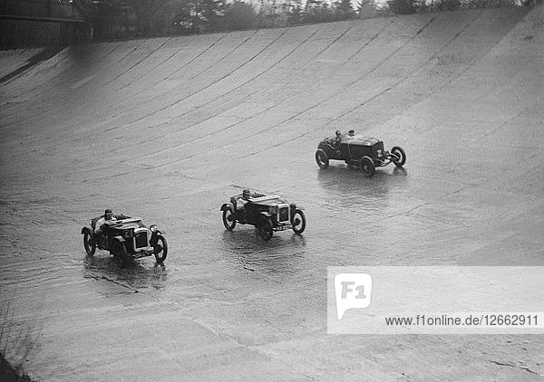 Two Austin 7s and an unidentified car racing at a BARC meeting  Brooklands  Surrey  1931 Artist: Bill Brunell.