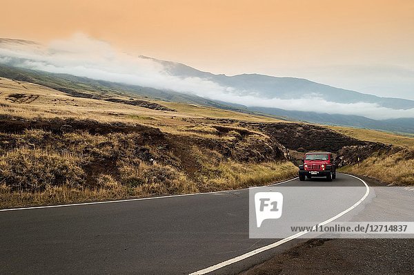 A jeep drives on the remote south shore of Maui  Hawaii  USA. That shore is well-known for its natural beauty  with hardly any buildings  resorts  golf courses  and other tourist facilities.