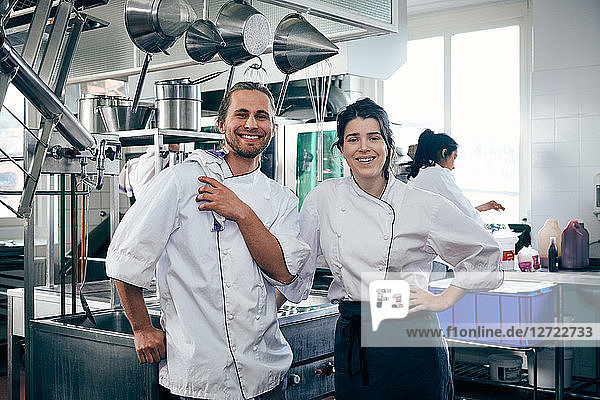 Portrait of chefs smiling in commercial kitchen