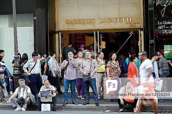 France  Paris  Chinese tourists waiting in front of Galeries Lafayette department store