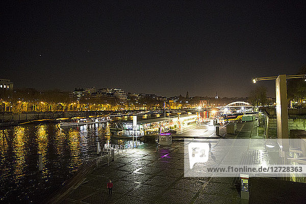 Night view on the quays of Paris with flies boats.