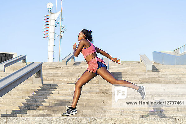 Young woman during workout on stairs