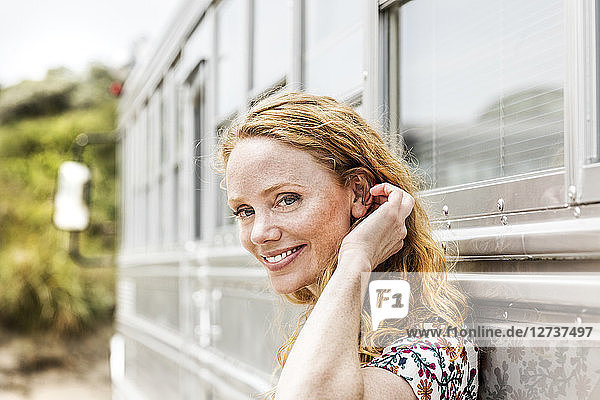 Portrait of smiling woman at an old bus