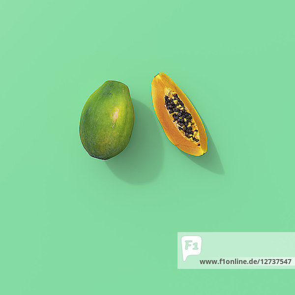 3D rendering  Sliced papaya on green background