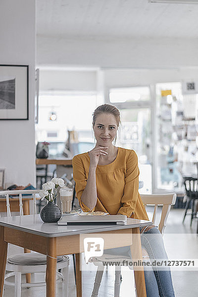 Young woman working in coworking space  taking a break