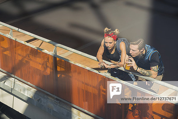 Young couple relaxing on parking level