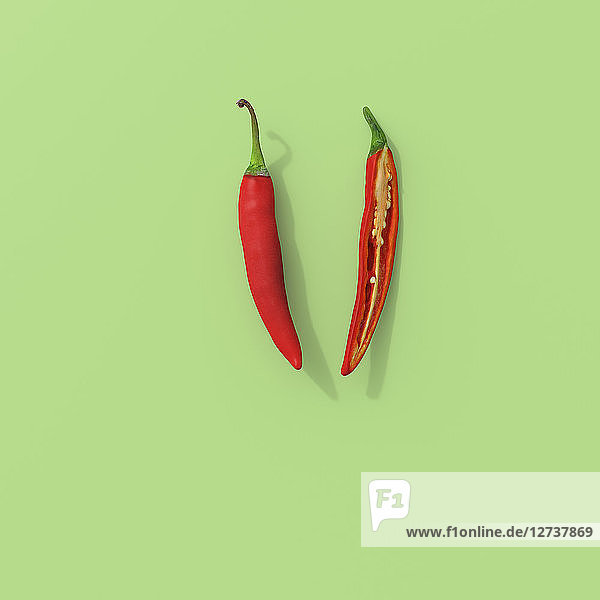 3D rendering  Sliced red chili on green background