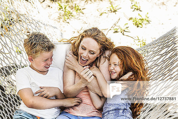 Happy mother with children in hammock