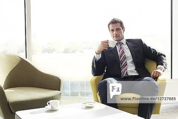 Poland  Warzawa  businessman having a coffee break at hotel lounge