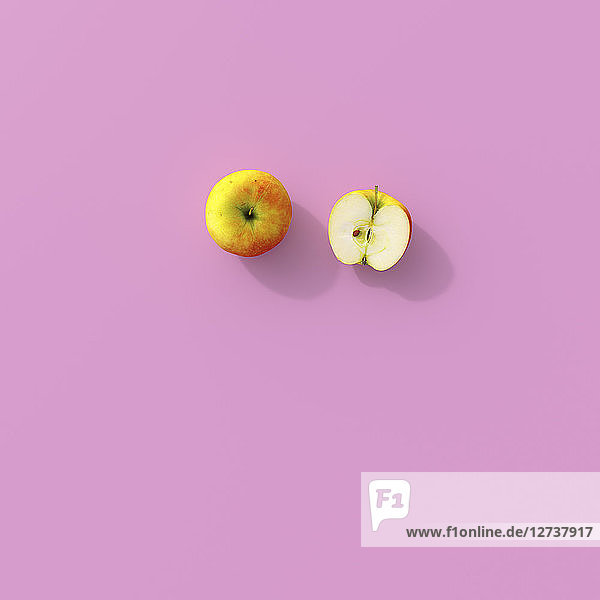 3D rendering  Halved apple on pink background