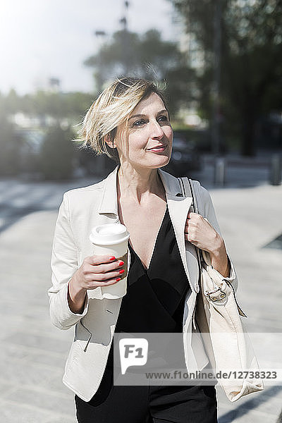 Portrait of relaxed businesswoman with Coffee to go