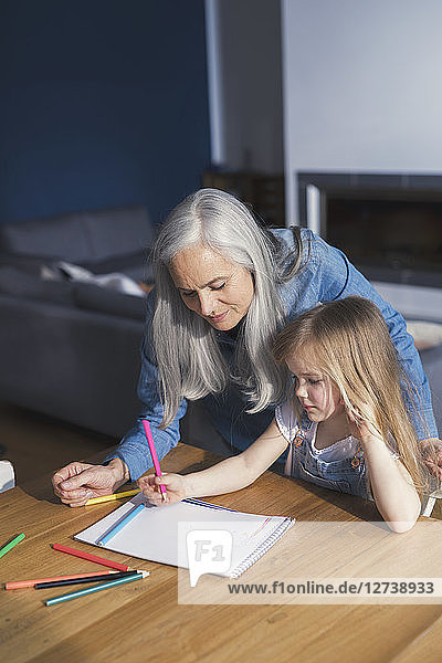 Grandmother and granddaughter making a drawing together