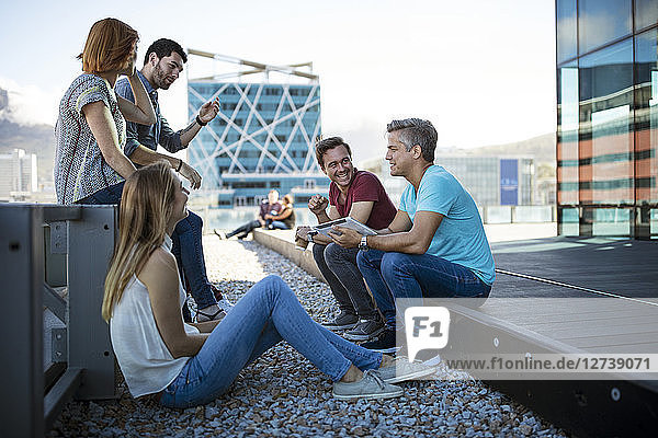 Business people having a casual meeting on a rooftop terrace