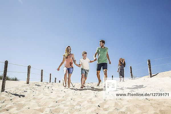 Netherlands  Zandvoort  happy family running on the beach